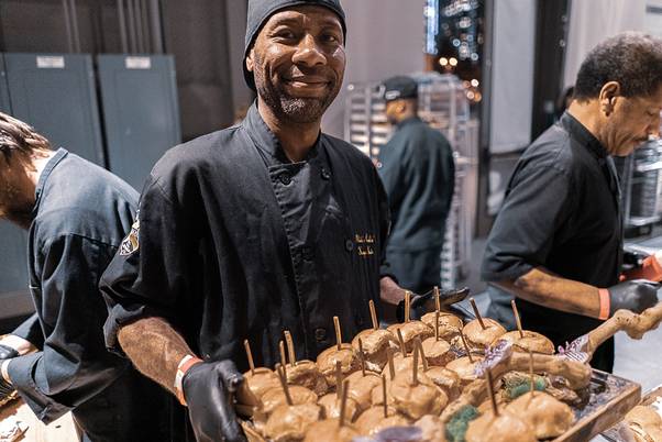 An Instawork Pro plating food at a catering event